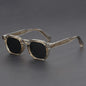 Sunglasses with clear frame and black lenses on a dark gray background